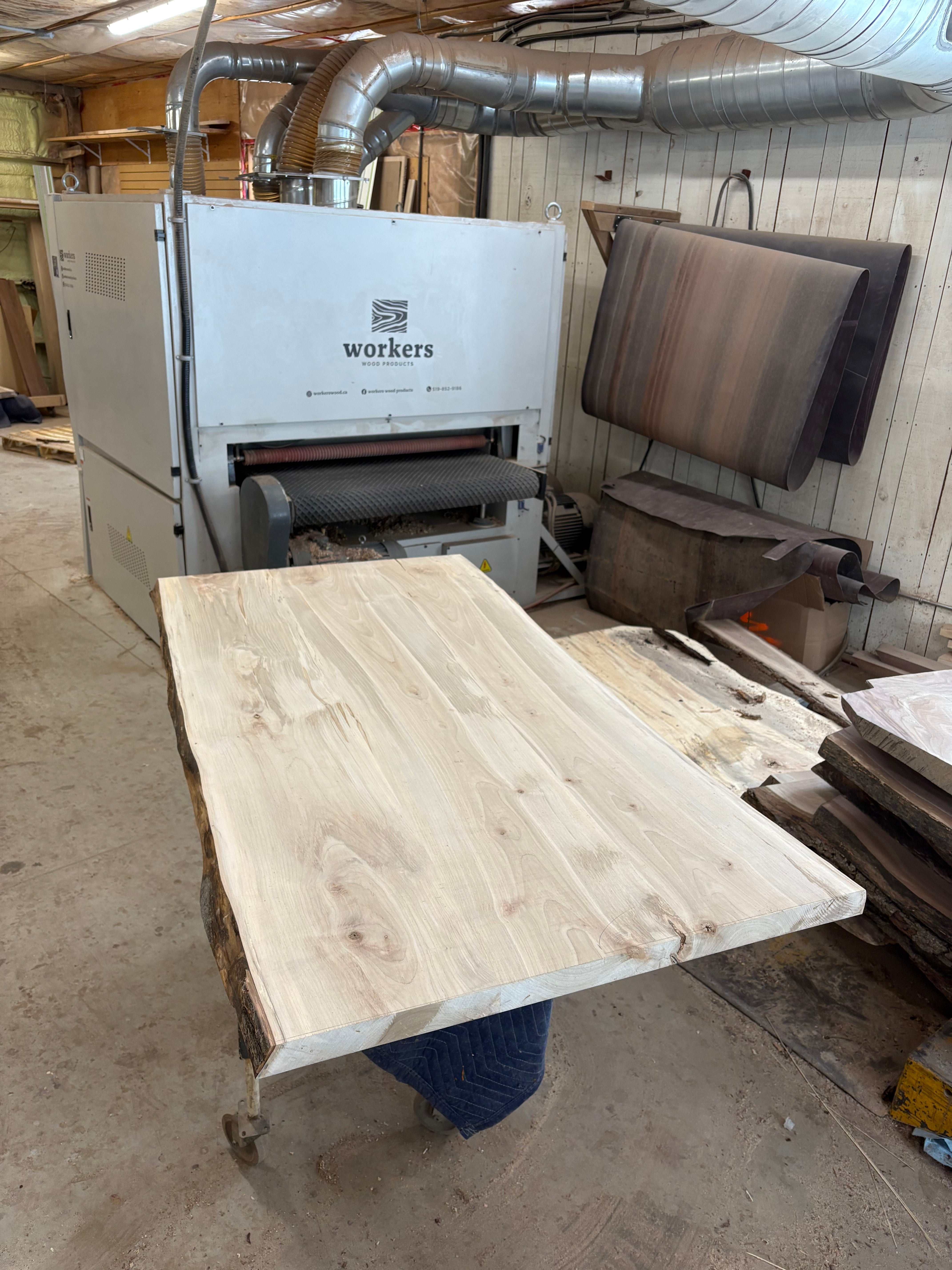Maple Live edge table top beside planing and sanding machine