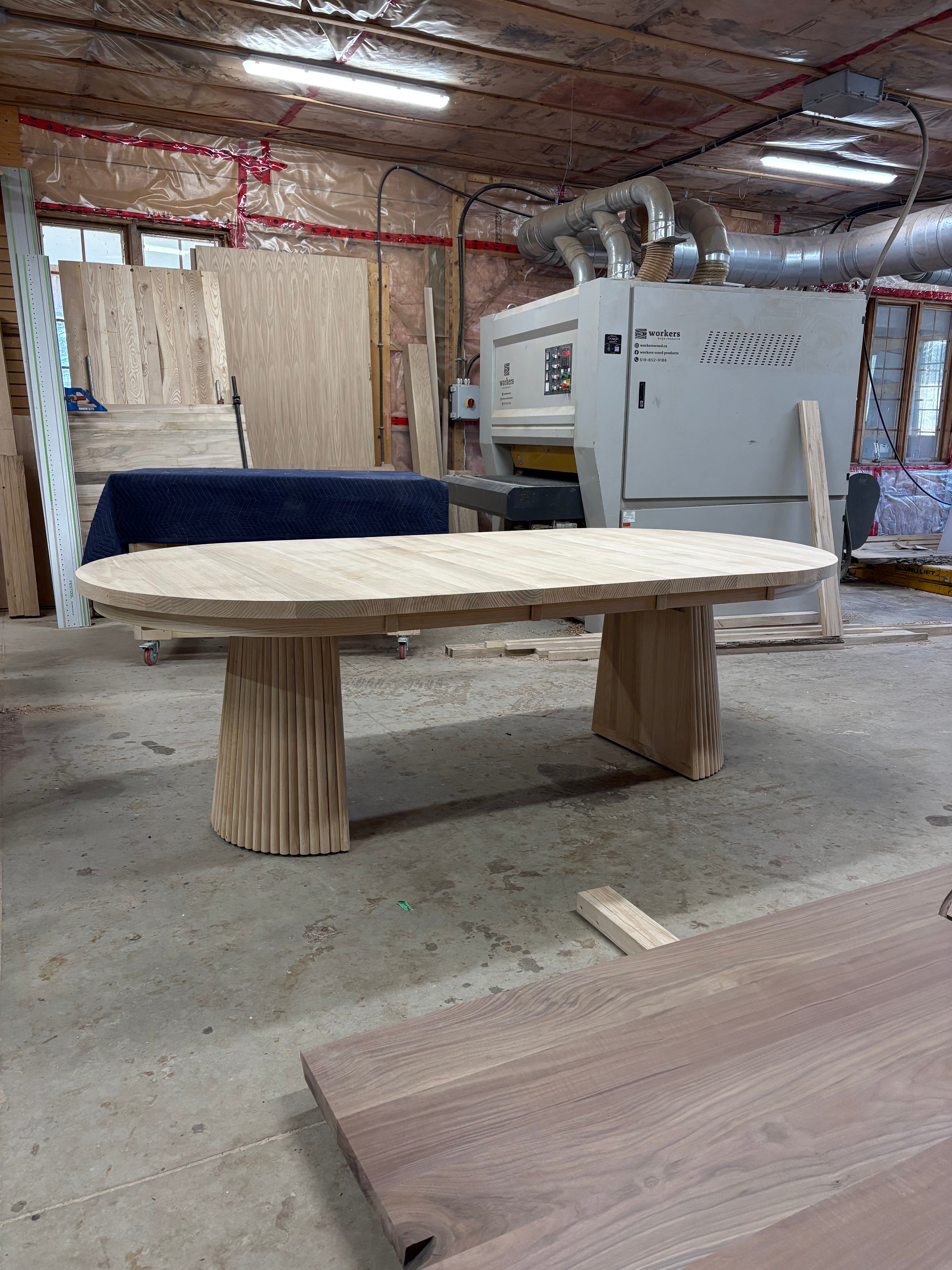 Round wood extendable table with tambour base
