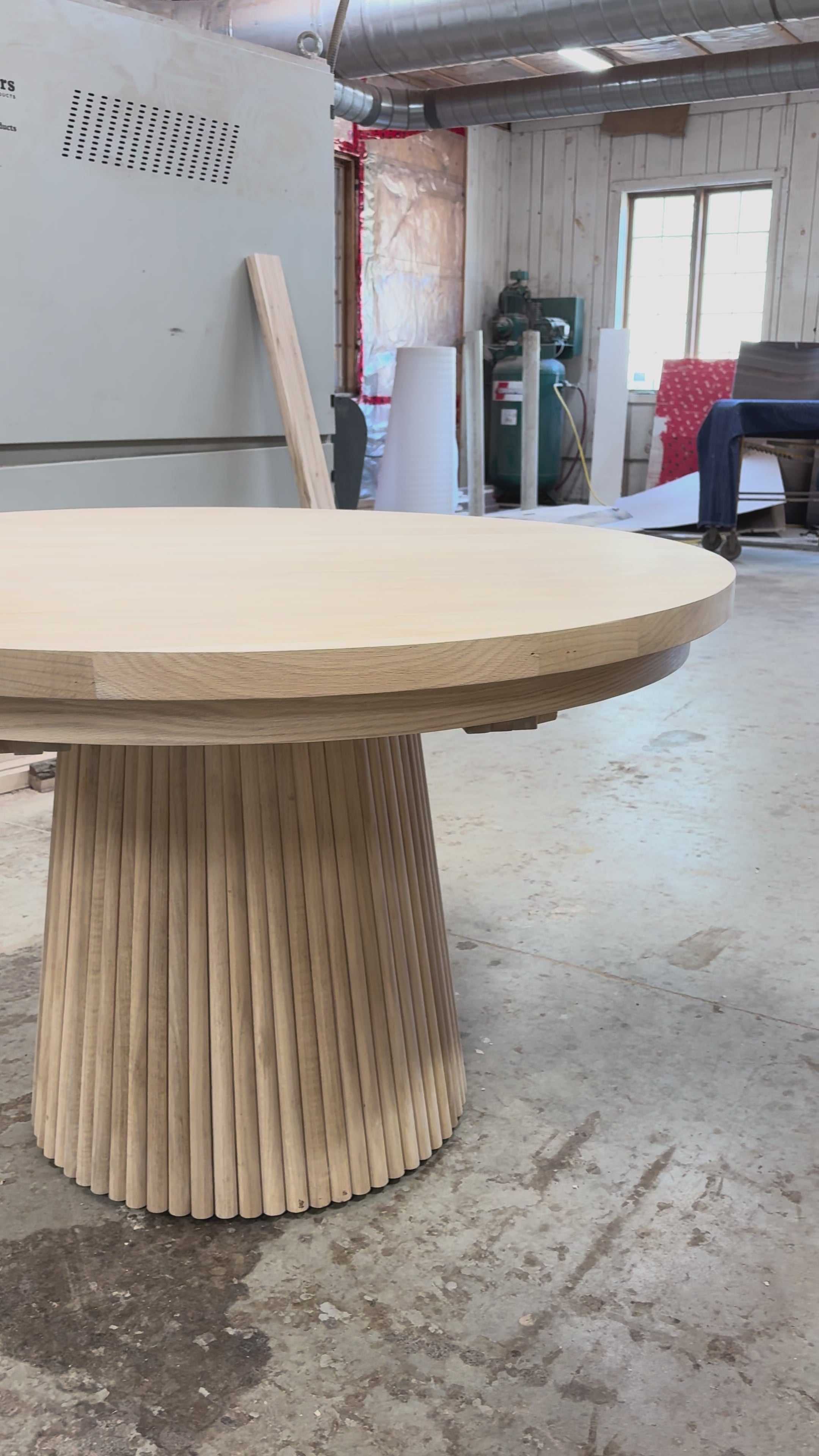 Round wood table with reeded base
